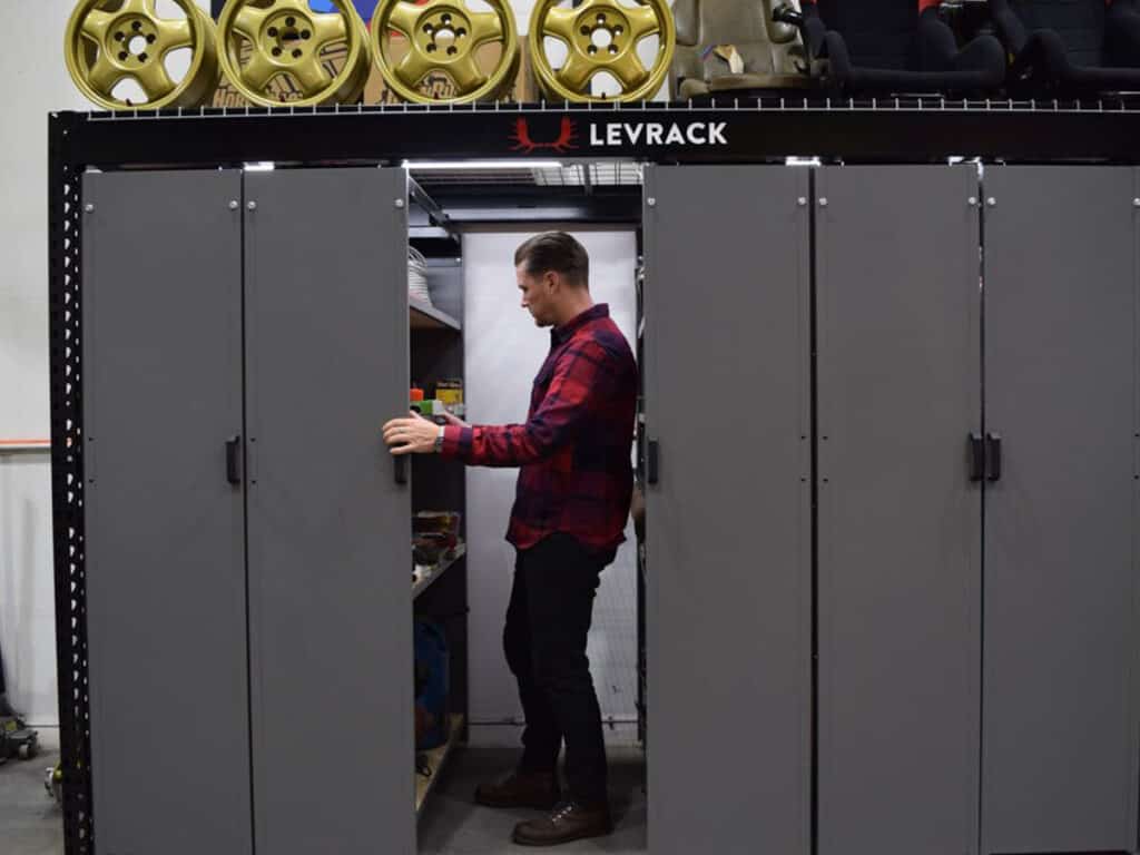 An image of a person using a Levrack shelving system.
