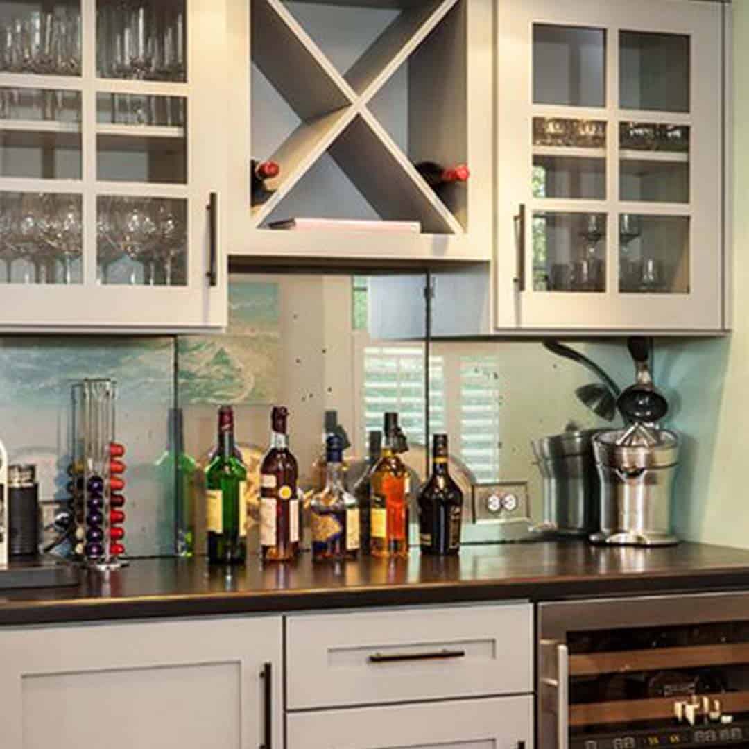 An image of customized kitchen cabinets and side bar.